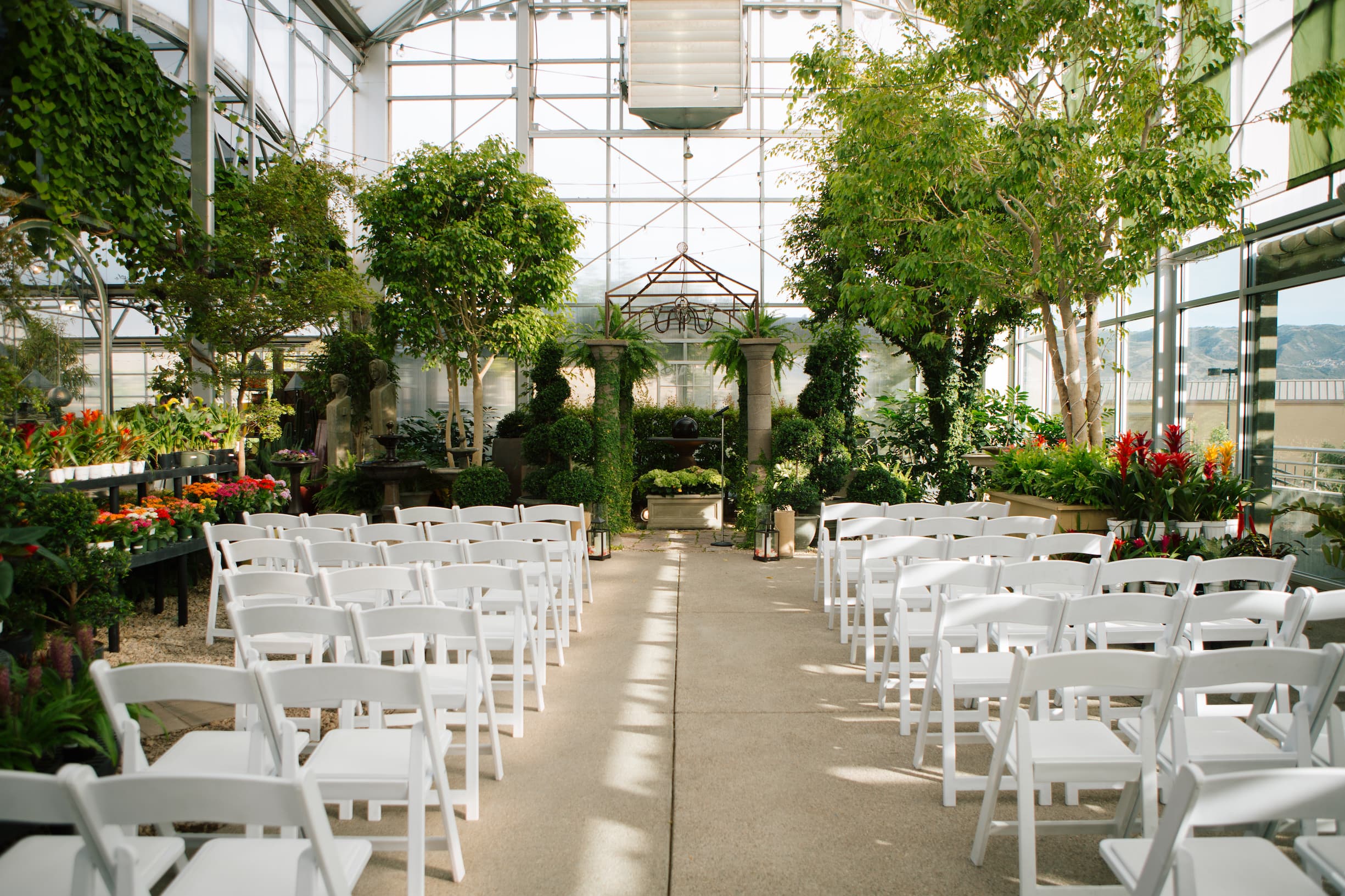 a room with white chair rentals and trees in sugarhouse utah